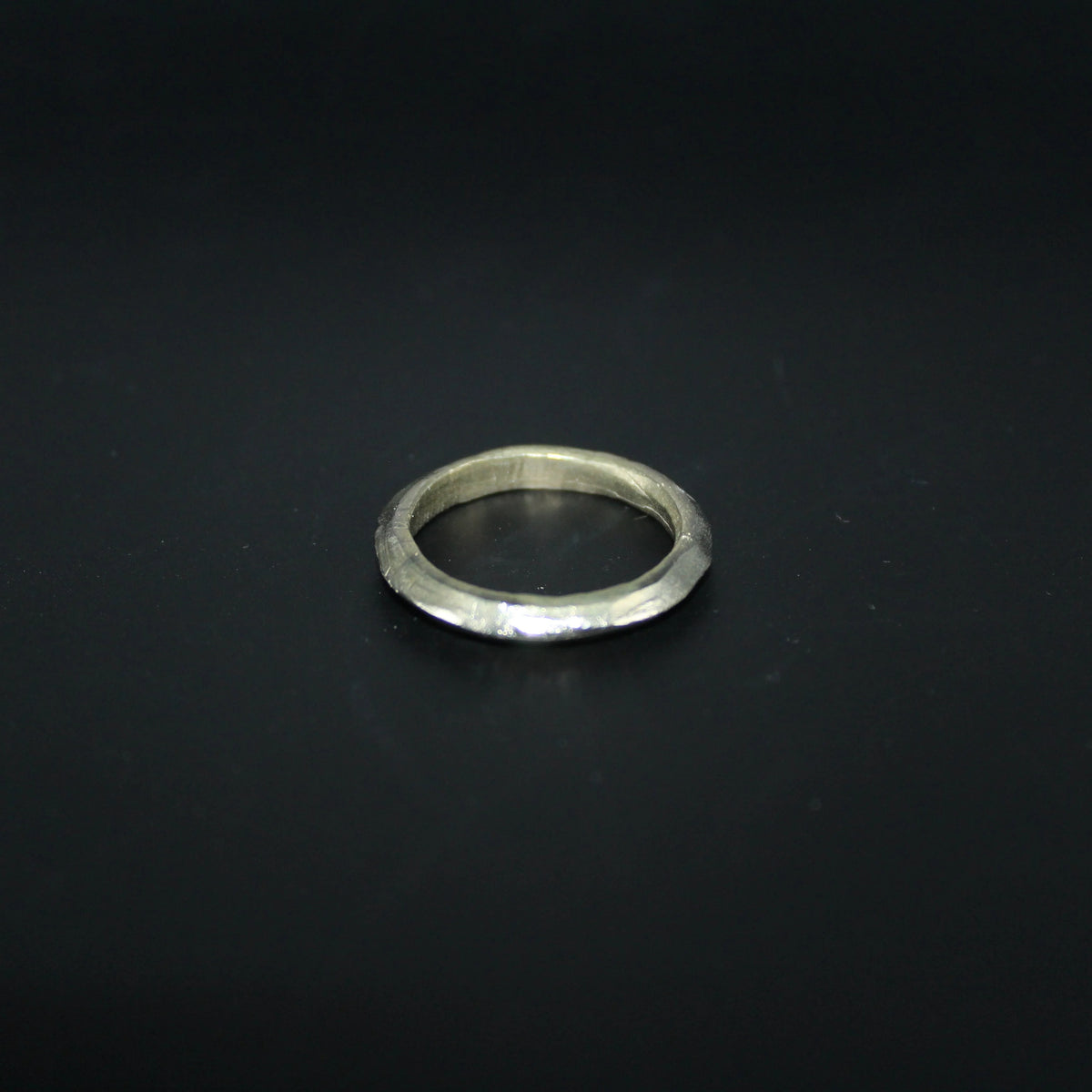 Silver ring on a black background