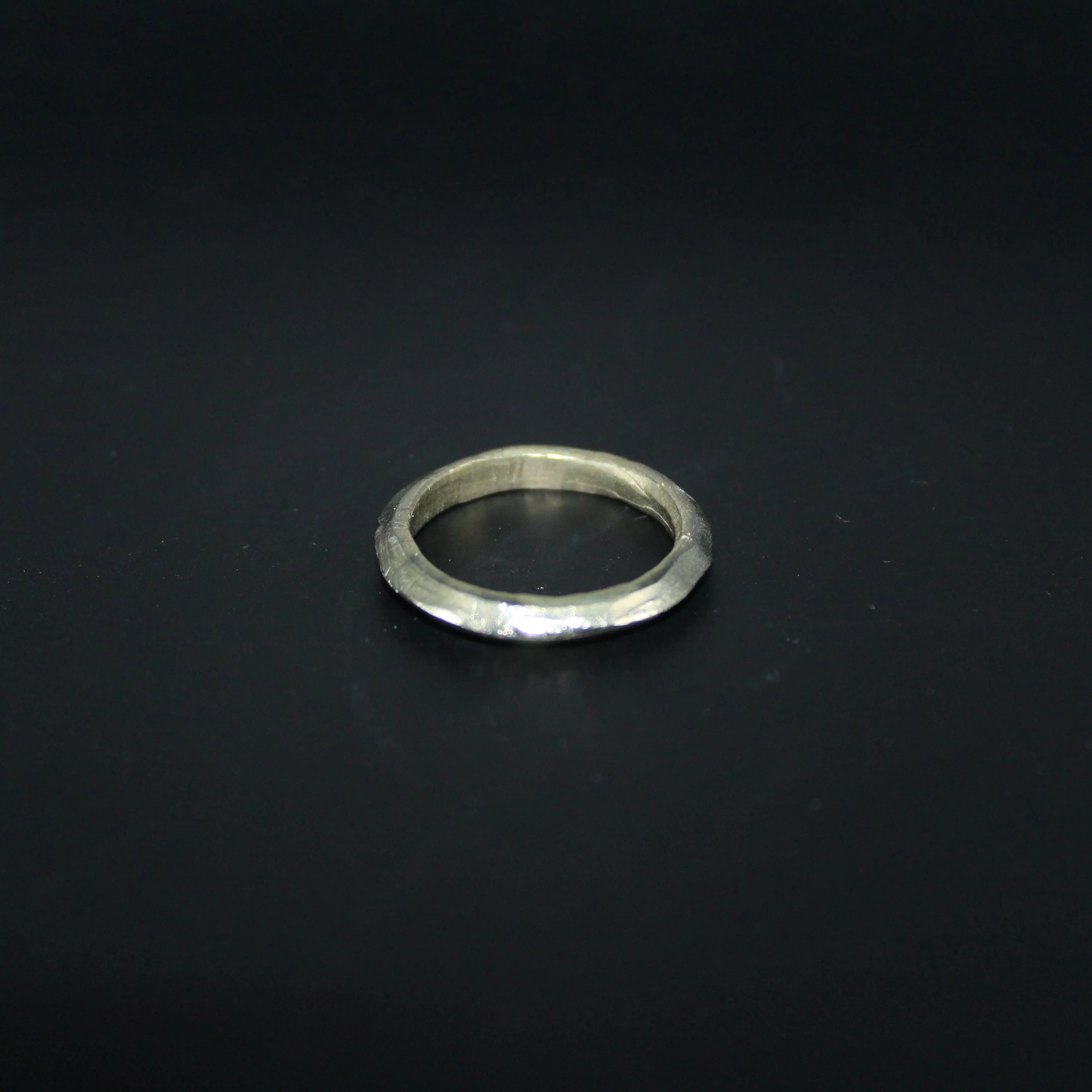 Silver ring on a black background
